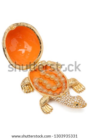 Opened box for juwellery in shape of golden turtle with bracelet