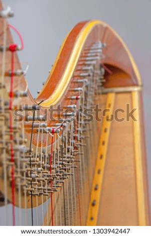 Abstract blurred close-up view of details of wooden harp. Original background with artistic bokeh. Music instruments series. Shallow depth of field
