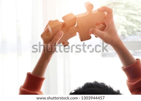 jigsaw puzzle holding by two people hands, together to success concept