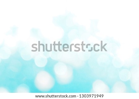 Beautiful abstract bokeh lights in green, turquoise and white tone for festive background, winter theme, and seasons greetings concept. Making glossy decoration and wallpaper.