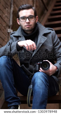 Portrait of a young promising guy photographer closeup