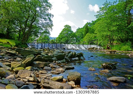 A waterfall and a mountain stream near Ambleside on a summers day in the Lake District National Park, Cumbria, United Kingdom