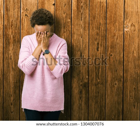 Beautiful young african american woman over isolated background with sad expression covering face with hands while crying. Depression concept.