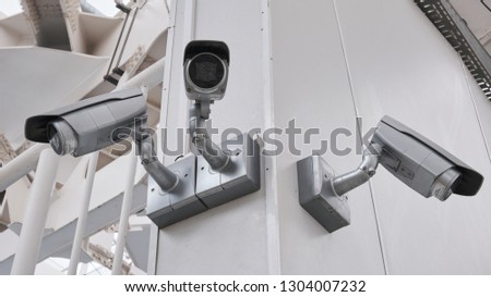 cctv camera security on pole and cement background Royalty-Free Stock Photo #1304007232