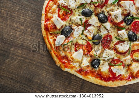 Pizza with Chicken meat, Mozzarella cheese, tomato, olive. Italian pizza on wooden background