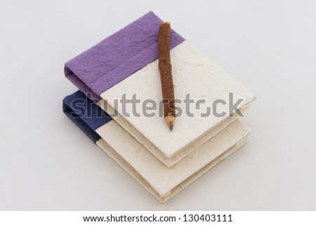 Handmade notebook and pencil isolated on white background