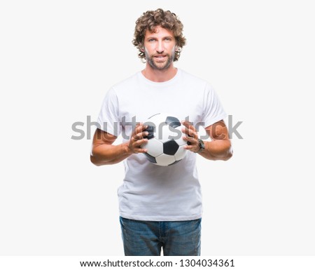 Handsome hispanic man model holding soccer football ball over isolated background with a happy face standing and smiling with a confident smile showing teeth