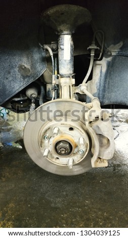 Car brake part at garage,car brake disc without wheels closeup