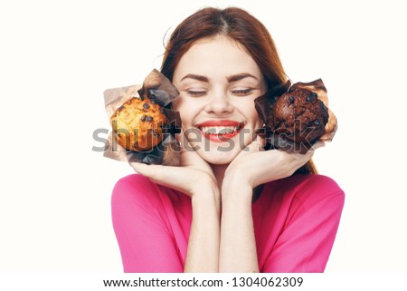 Beautiful woman with flour products in hands on a light background smiling at the camera                          