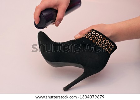 Impregnation of suede boots for winter and moisture. Royalty-Free Stock Photo #1304079679