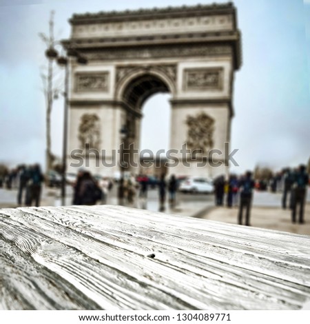 Table background of free space for your decoration and Paris city landscape. Blue sky and wet street. 