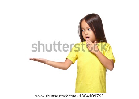 Little girl in yellow t-shirt holding her hand out