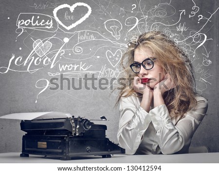 beautiful journalist looks typewriter Royalty-Free Stock Photo #130412594