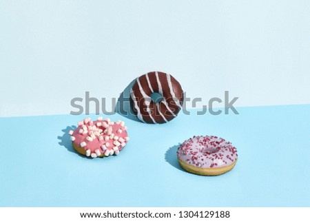 Three Colorful donuts on a blue background