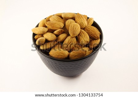 Almonds in black bowl.