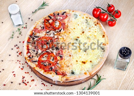 Close up view on pizza on white wooden background with ingridients. Italian cuisine. Ready to Eat. Restaurant, food menu, recipe, cafe concept. Lifestyle with copy space