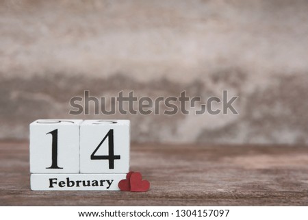 Valentines day with february 14th. Wooden white block calendar and Red heart on wood table background with copy space