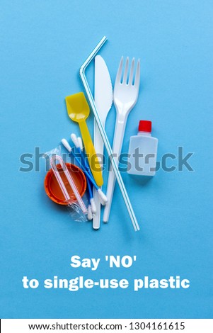 White single-use plastic and plastic drink straws on a blue background. Say no to single use plastic. Environmental, pollution concept. Royalty-Free Stock Photo #1304161615