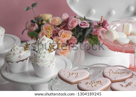 Candy bar sweet table. Table with sweets, muffins,heart cookies,flower,macaroons - Image
