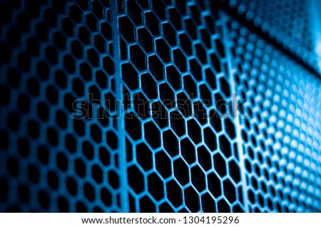 Abstract geometry background with hexagonal shapes, honeycomb seamless pattern texture with blur light defocus effect, technical ventilation grid backdrop. Metal wall, computer. Design wallpaper