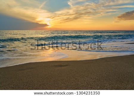                         Tropical sandy beach. Sunset seascape. Waves with foam hitting sand.