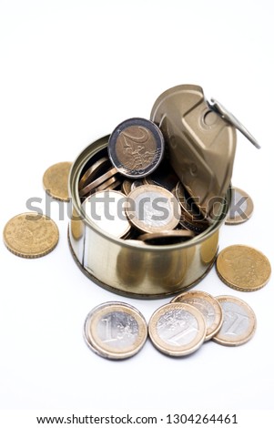 Coins in open tin on white background