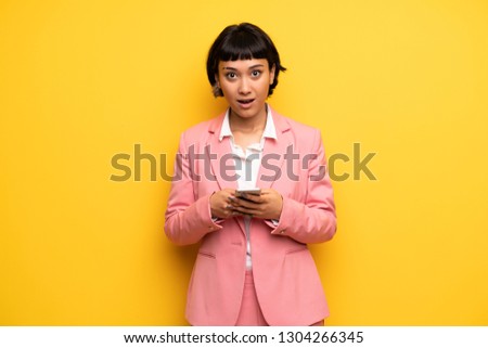Young woman with short hair talking to mobile