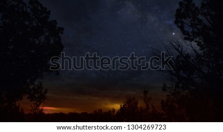A blue starry sky flying above the remaining orange sunset still hanging on the horizon in Arizona.