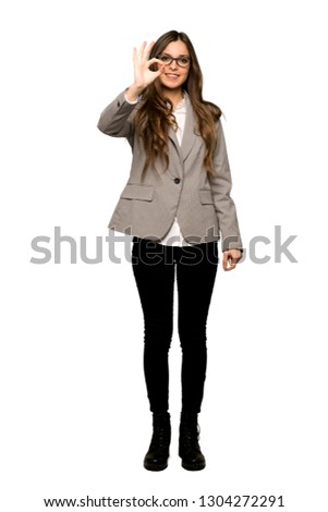 Full-length shot of Business woman showing an ok sign with fingers on isolated white background