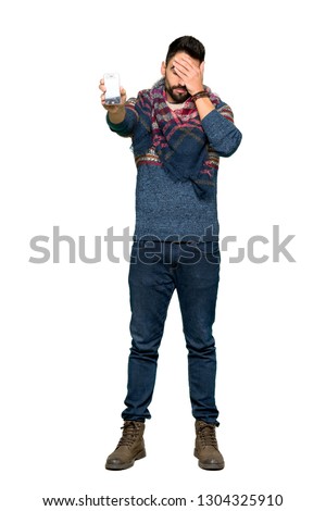 Full-length shot of Hippie man with troubled holding broken smartphone on isolated white background
