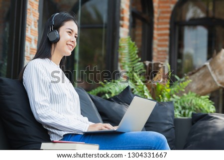 beautiful teen ,girl using notebook computer,listening to music with happy.