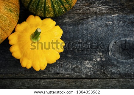 Pumpkins and squash on wooden background
