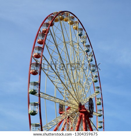 Entertainment Ferris wheel against the clear blue sky