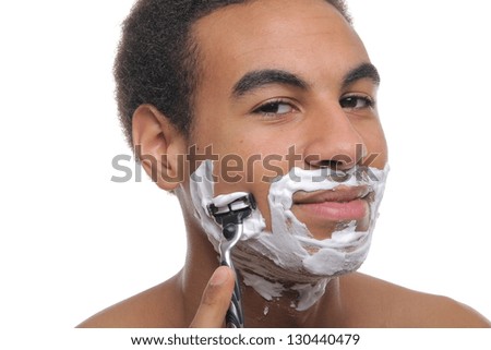 Young attractive man shaving