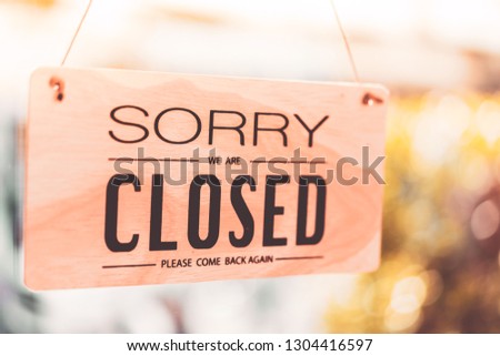 Closed sign hanging front of cafe mirror door. Business service and food drink concept. Vintage tone filter effect color style.