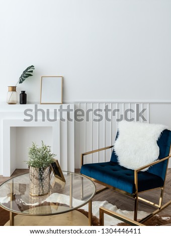 Cozy living room corner with gold and blue velvet fabric armchair and gold mirror coffee table in modern classic style with natural light setting scene / studio shot / interior design decoration