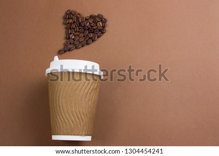 top view paper coffee to go cup and heart made from coffee beans, , copy space, brown background