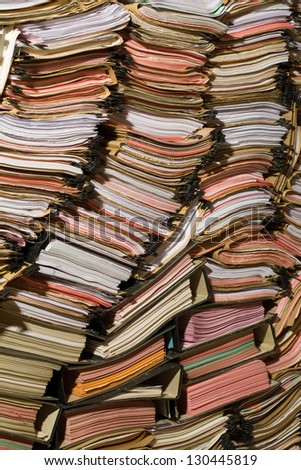 Stack of documents, papers and full binders Royalty-Free Stock Photo #130445819