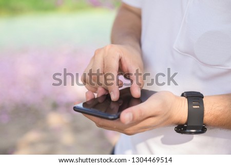 Close up image of male hands using smartphone, searching or social networks concept