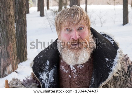 Bearded man in the winter woods. Close up portrait of a bearded man in the winter.