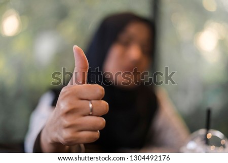 Closeup. woman showing thumbs up.Happy business person giving satisfied and supportive hand gesture.