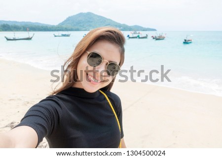  woman tourist is selfie  in Phuket sea in Thailand 