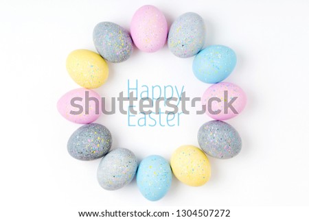 Stylish Frame of pale pink, blue and gray Easter eggs with copy space for text. Flat lay