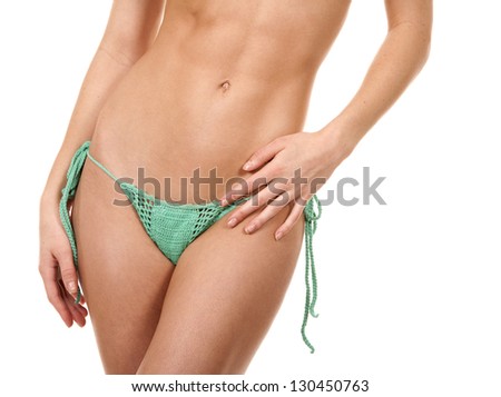 pretty fitness model posing in green bikini on white background