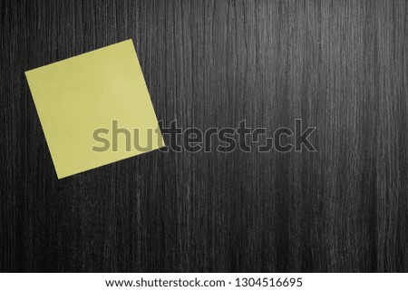 yellow sticky notes on a dark wooden table. concept picture for office, home. 