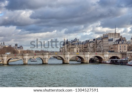 Panorama of Ile de la Cite, the Conciergerie and Pont Neuf on a cloudy day in winter - Paris, France