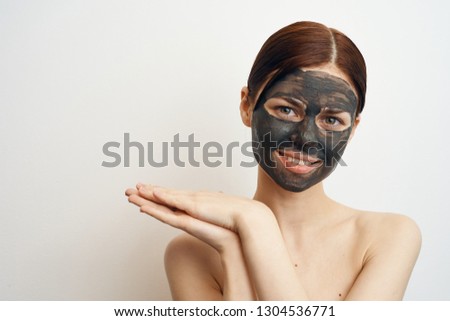woman smiling in a cosmetic mask