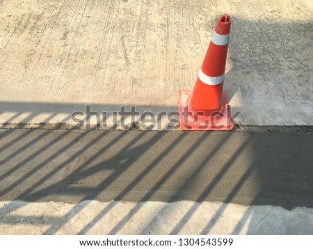 Wet cement and traffic cone