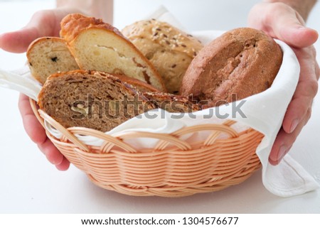 Bakery business. Startup concept. Wicker basket with bread assortment in hands.