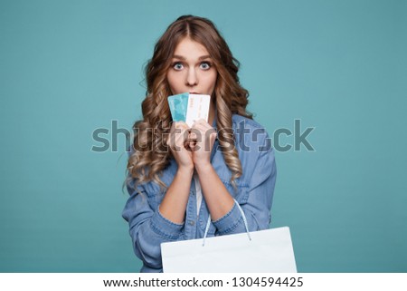 Nice picture of pretty model on blue backgrownd posing with credit cards